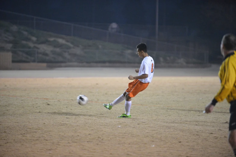 soccer player about to kick the ball in an open field