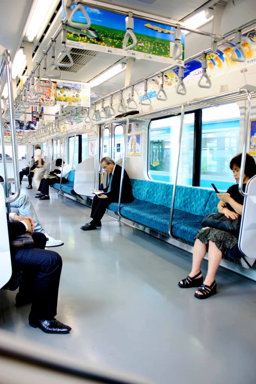 a group of people sit on a public bus and talk