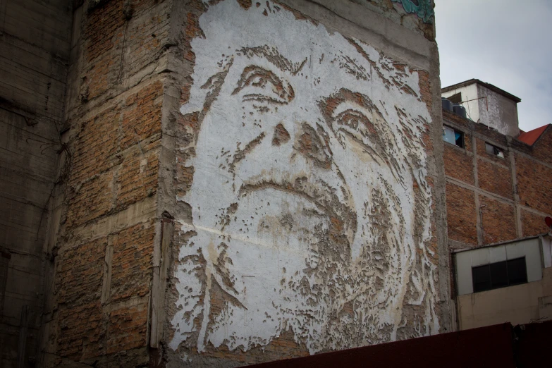 an image of a man drawn on the side of a building