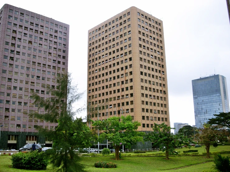 two brown buildings in the middle of a city