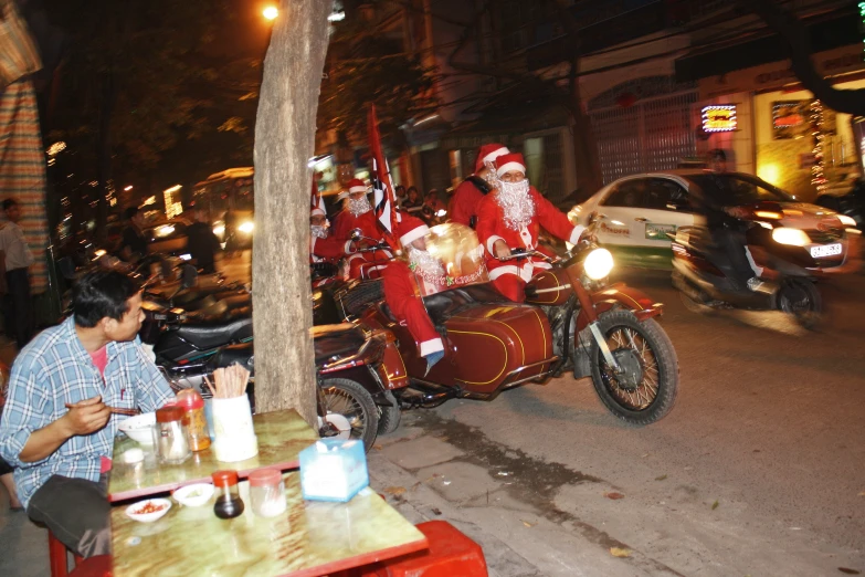 santa is on his motorcycle in the middle of the road