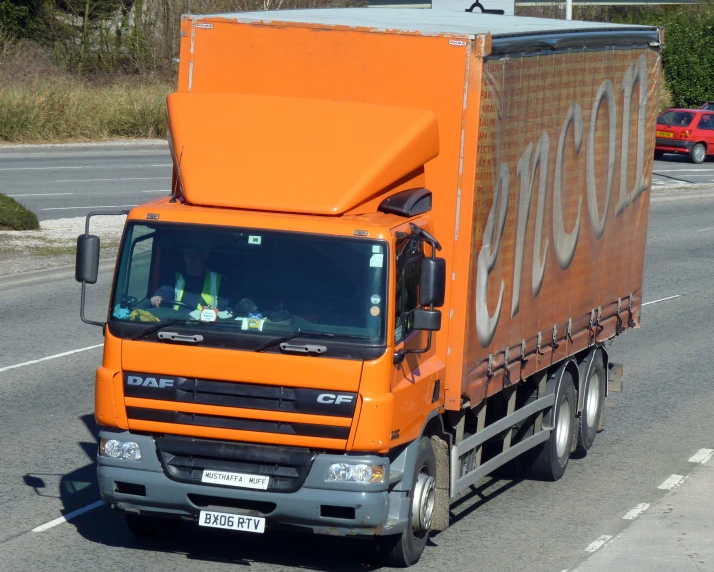 a truck on the road with a box in the back