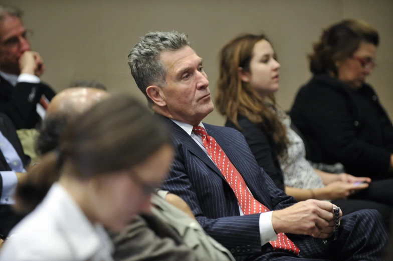 man in business suit at meeting looking concerned