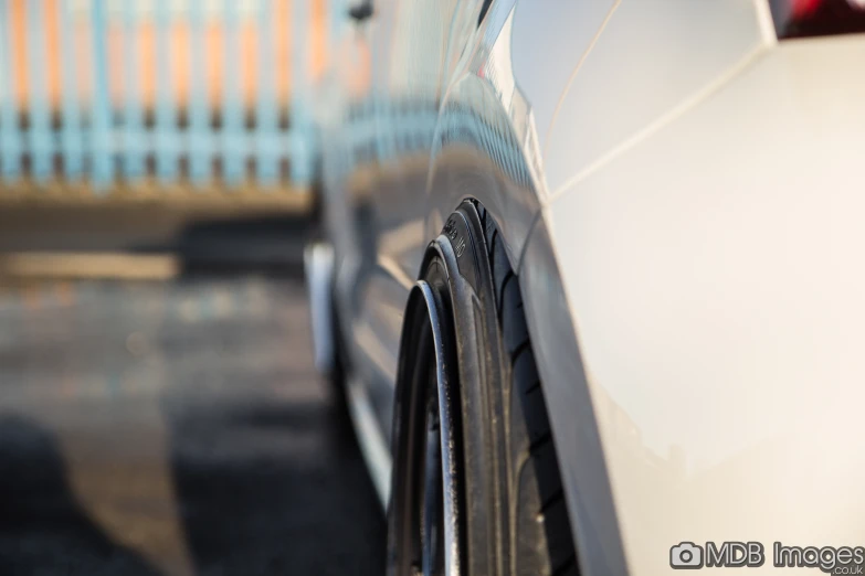 a closeup po of a vehicle bumper, it has a ke ring and has an extended tire arch