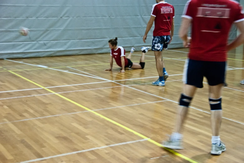 the men are learning how to play volleyball