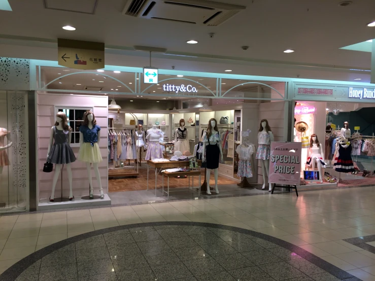 several women looking in their own store window display