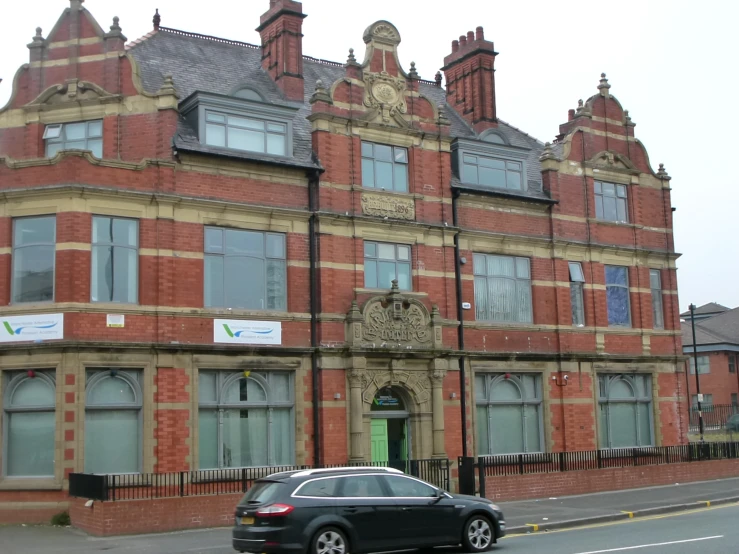 the car is parked in front of the building