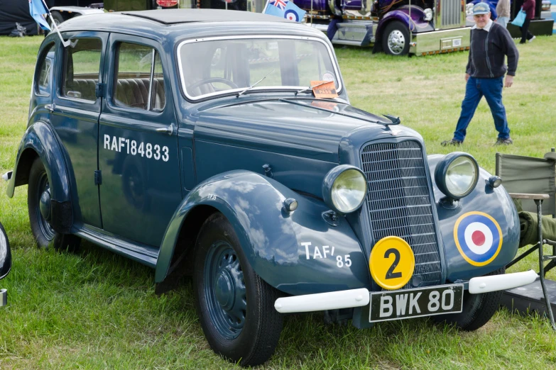 a very old car is in the grass