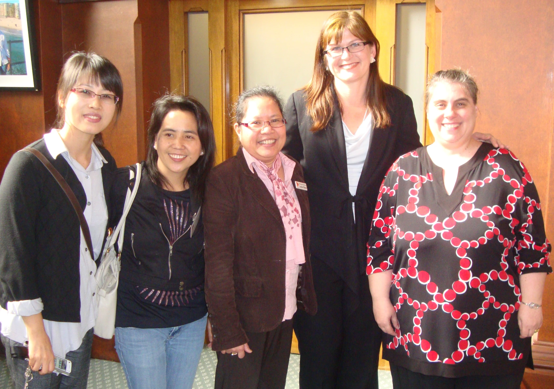 a group of women are smiling at the camera