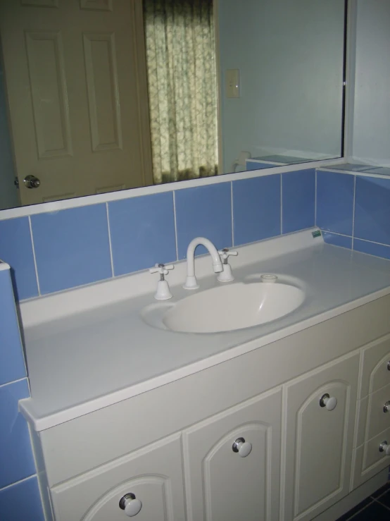 a bathroom vanity with drawers and a sink