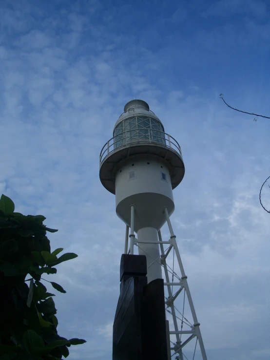 a white tower with a blue top under a clear sky