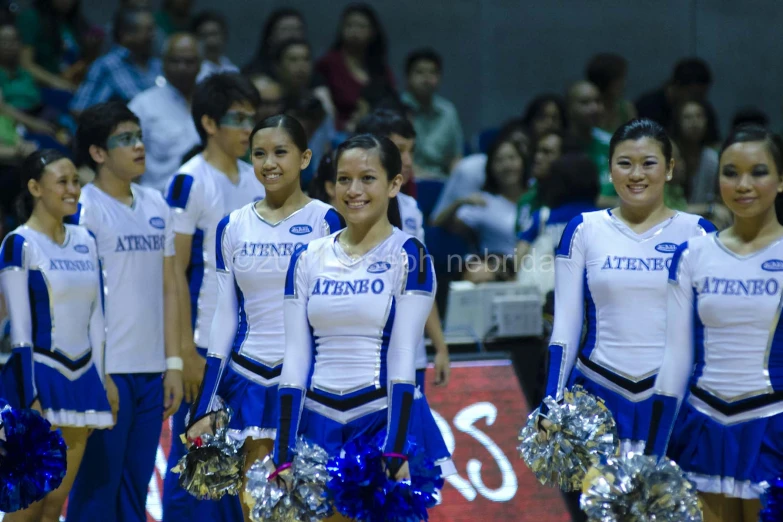 a bunch of cheerleaders standing in line at a game