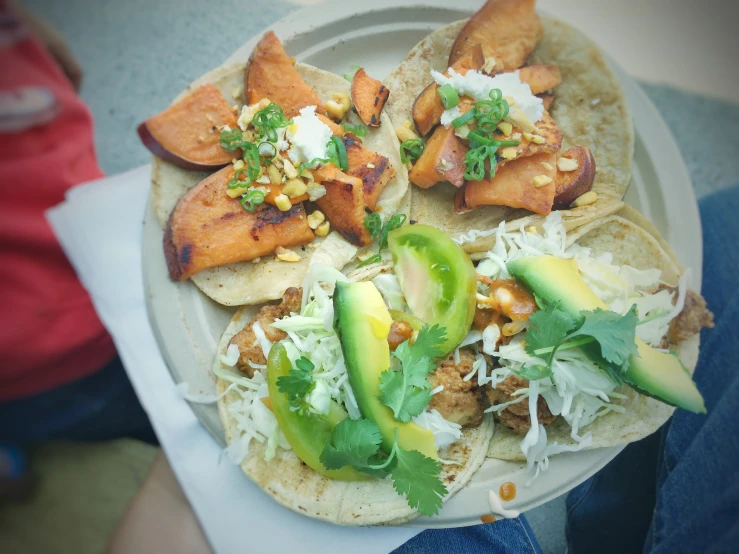 the tacos are topped with various vegetables and toppings