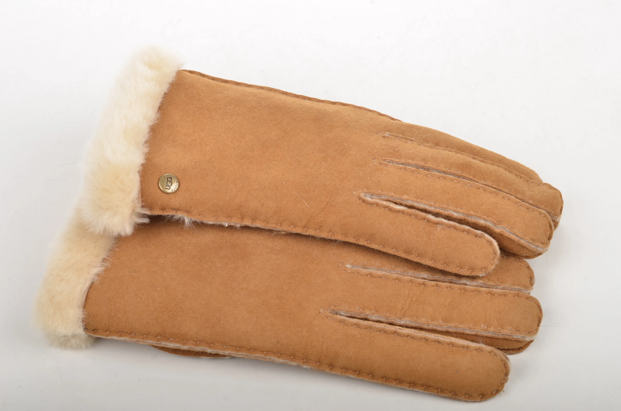 sheepskin gloves are lined up next to each other