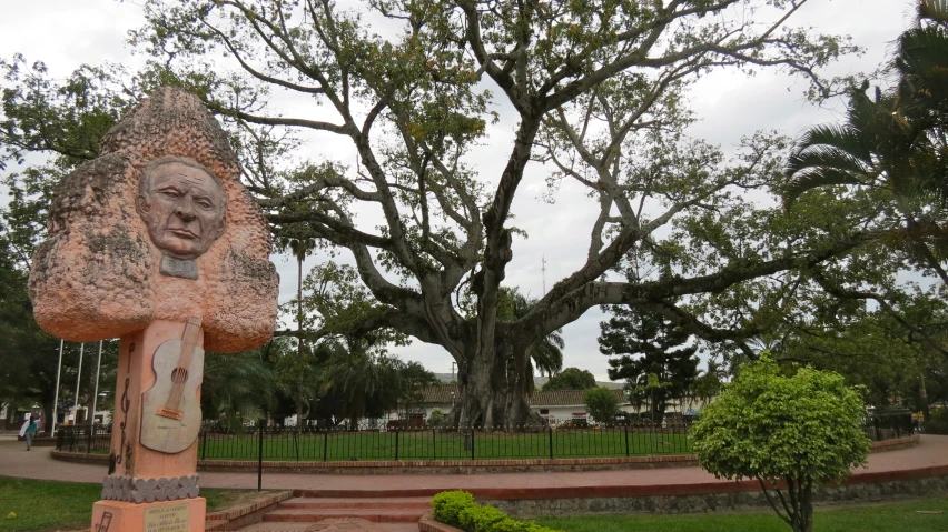 a statue sits in the middle of a garden