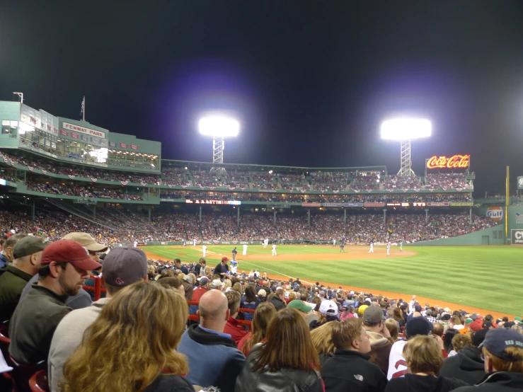 a baseball field filled with lots of people