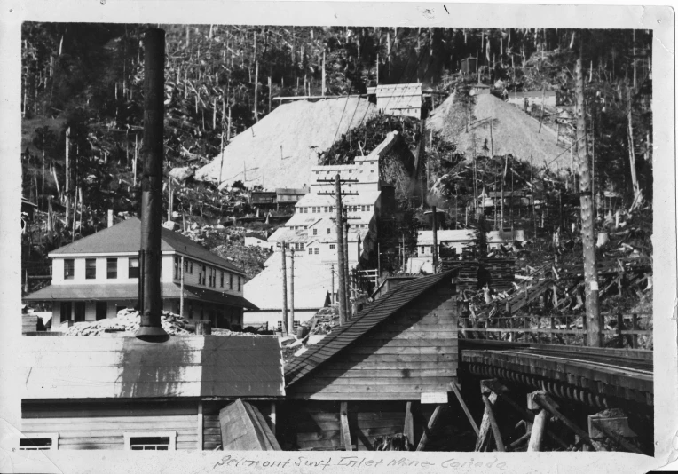 an old black and white po with mountains in the background