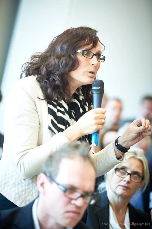 a woman giving a speech to an audience