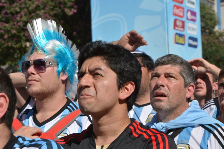 a group of fans wearing silly hats in the sun