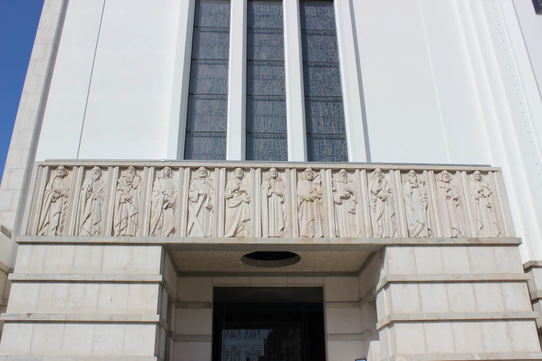 a large white building with many windows and a decorative design above