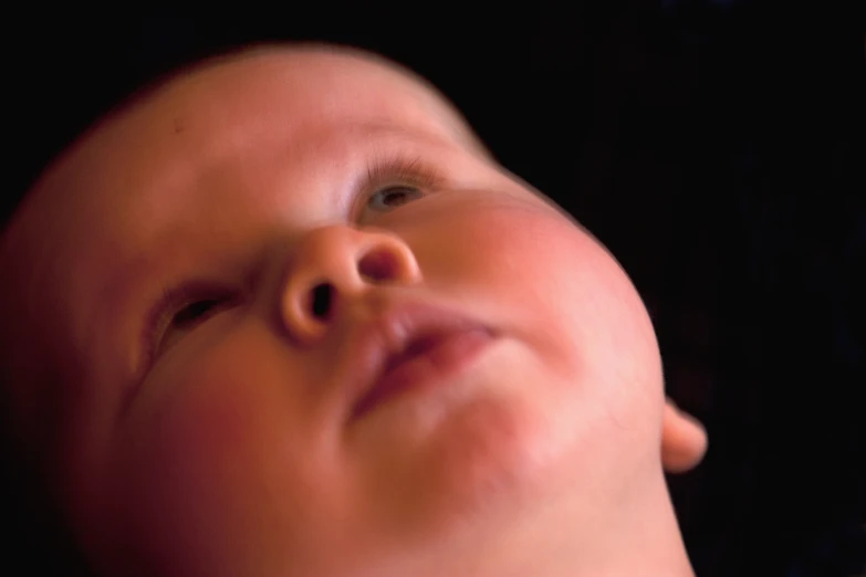 a close up po of a young child with closed eyes