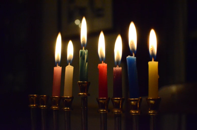 many candles are lit with small ones and one light on each side