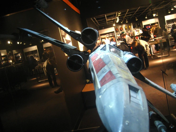 two people looking at old aircraft inside the museum