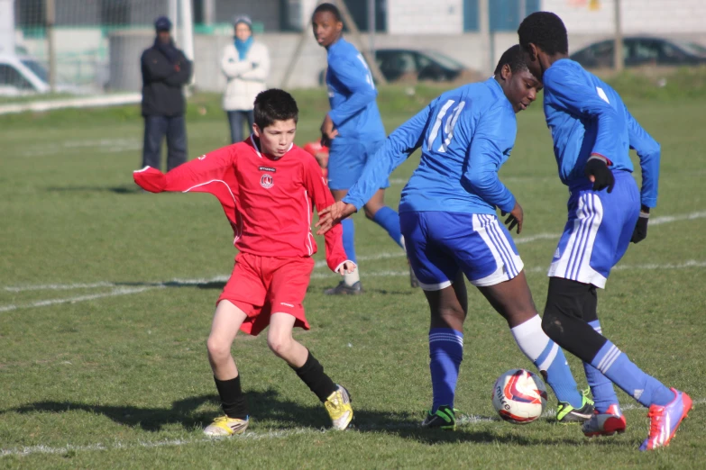 soccer players in red uniforms during a game