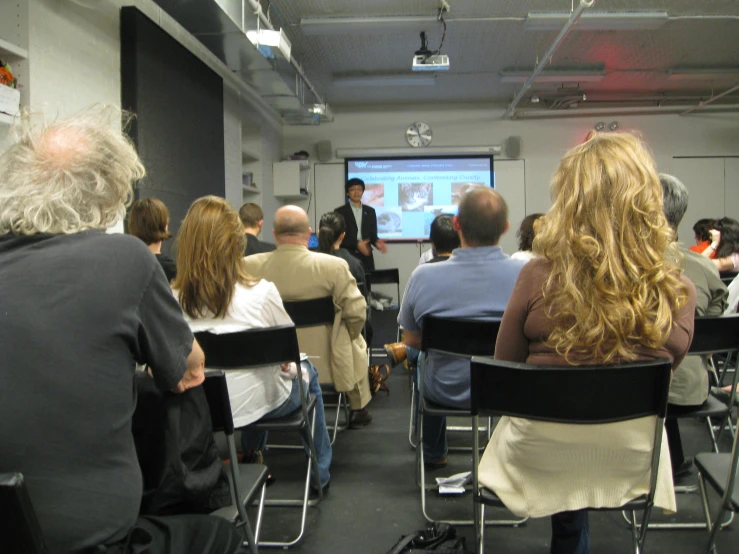 the people are listening to the speakers at the conference