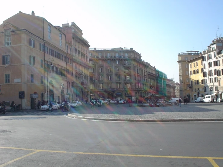 a round paved area in front of many colorful buildings