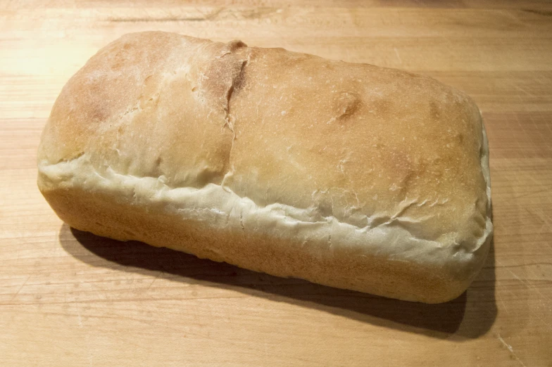 a loaf of bread sitting on top of a wooden table