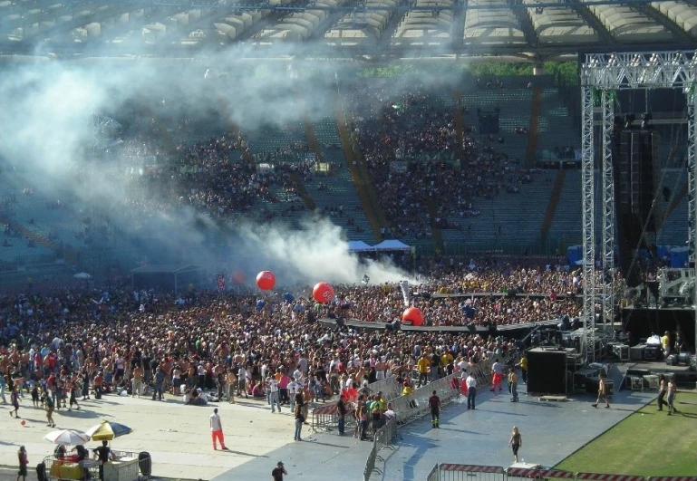 smoke rises from the stage as fans perform