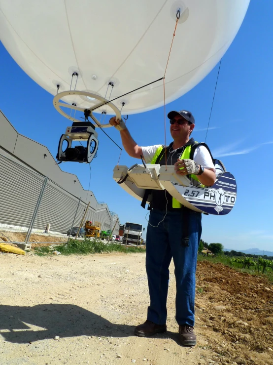 a person holds up the wing of a parachute