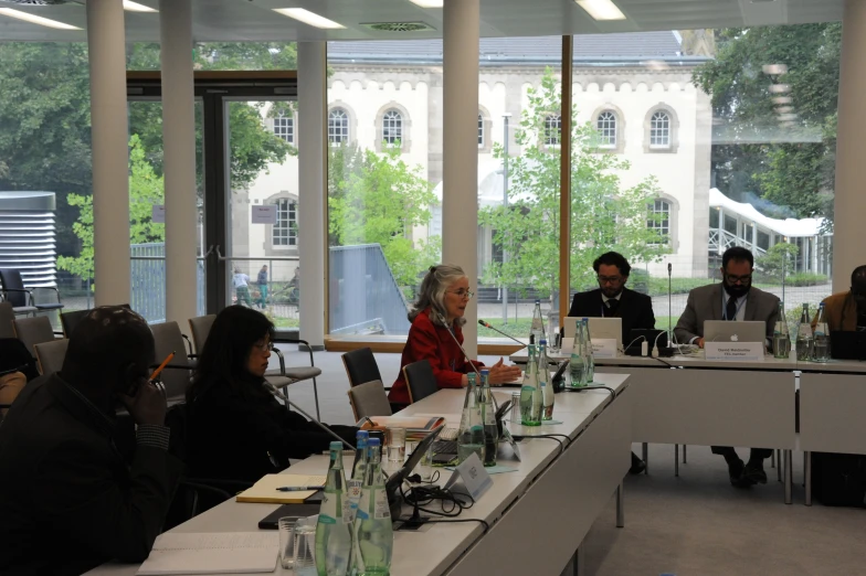 a group of people sitting around tables working