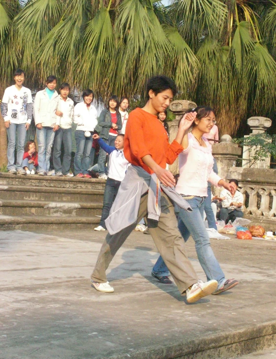 people sitting and standing next to each other by steps