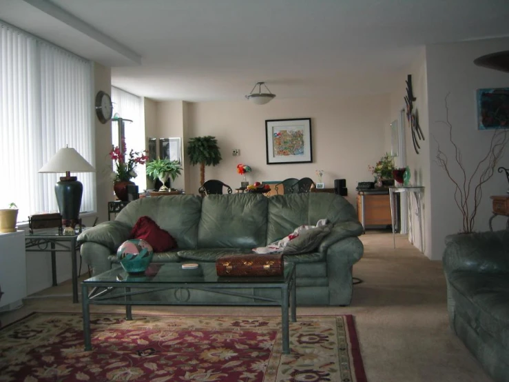 a living room with a light green couch and coffee table