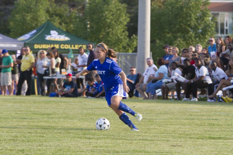 two people playing soccer in front of an audience