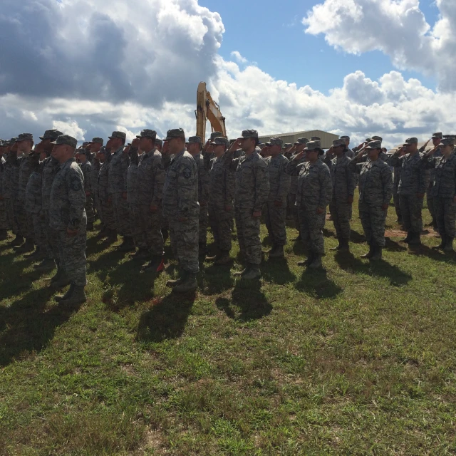 a group of men and women in military uniforms stand at attention