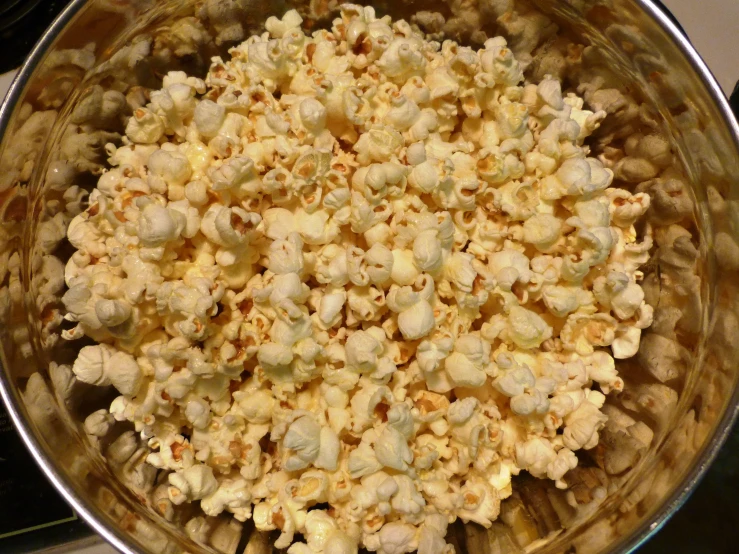 a glass pan filled with some cauliflower on a stove