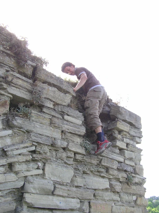 a man is climbing up a wall