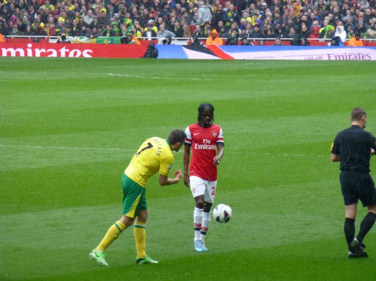 a couple of men on a field playing soccer