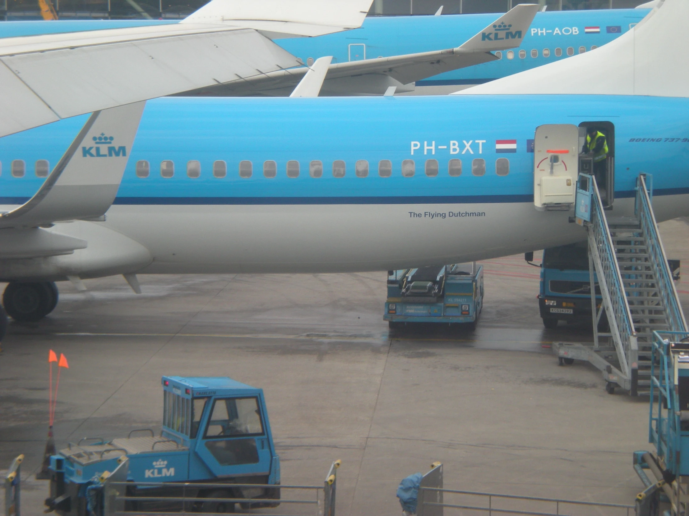 a blue airplane is parked on the runway