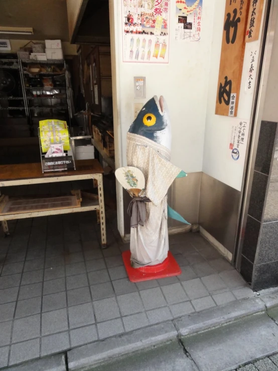 a statue wearing a hat with other items behind it