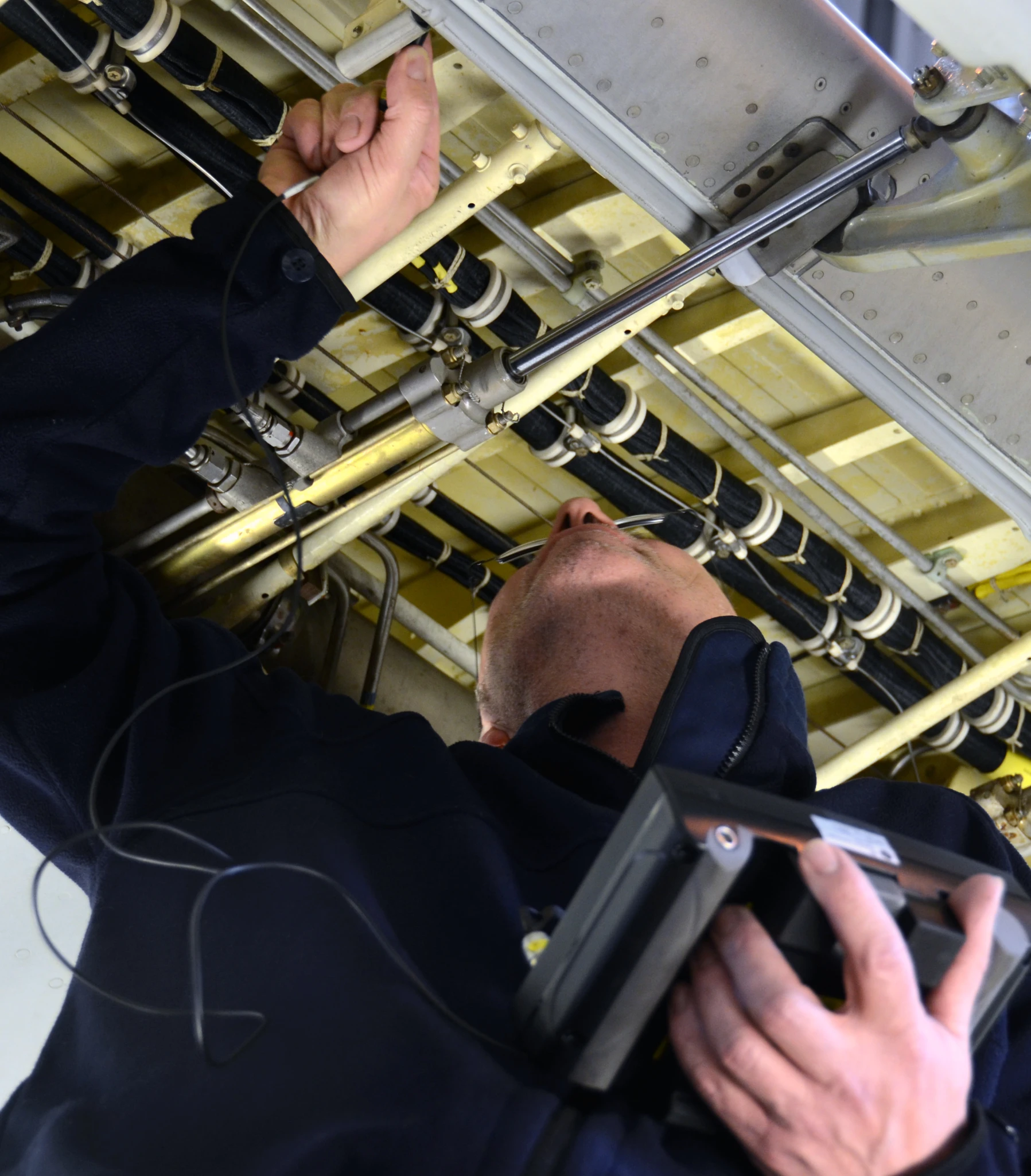 a man fixing and installing the ceiling in a repair shop