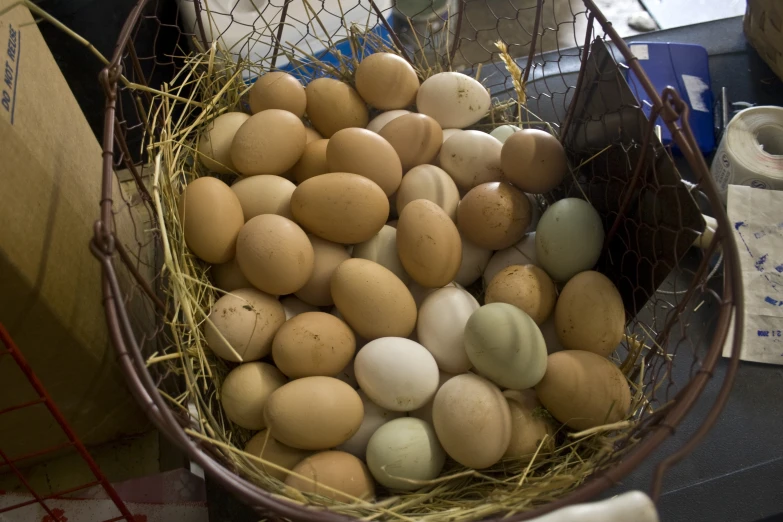 a basket full of eggs in some hay