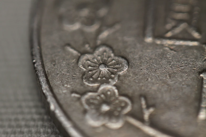 a closeup s of a coin with intricate designs