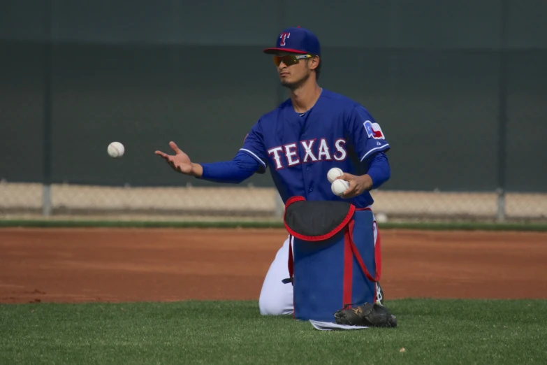 a baseball player throws a ball in mid - throw