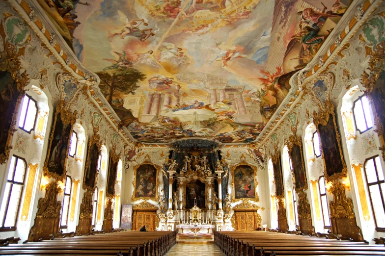 the interior of an elaborate painted church with alters