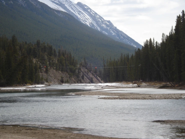 a scenic view of a river and mountains