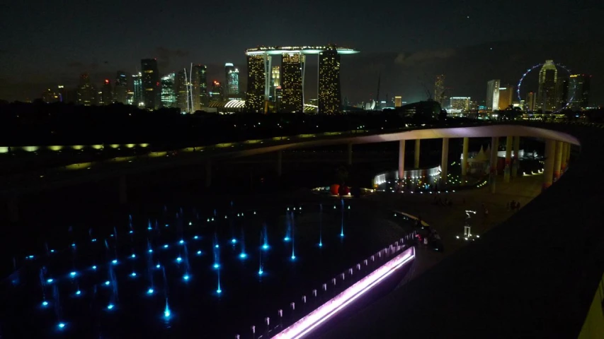 the lights on the fountain are reflecting in water